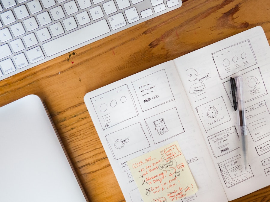 Photo: Wood Desk with Sketchbook, Keyboard, and Laptop