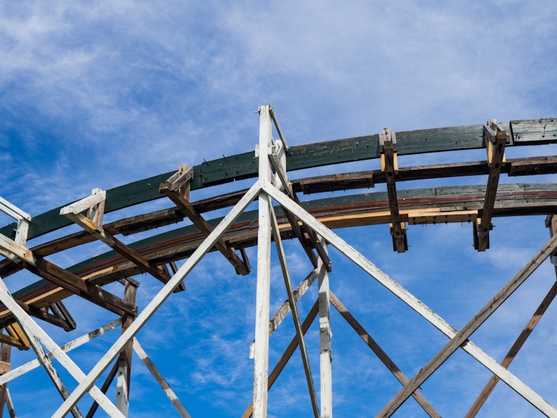 Photo: Wooden Rollercoaster Tracks Under Blue Sky