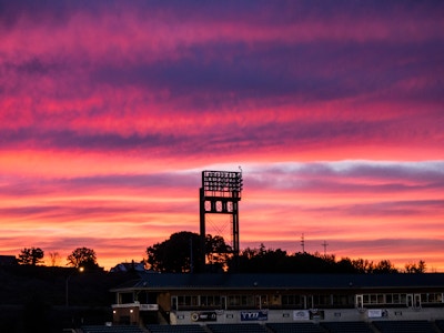 Baseball Stadium - A silhouette of a baseball stadium sign during a pink and purple sunset