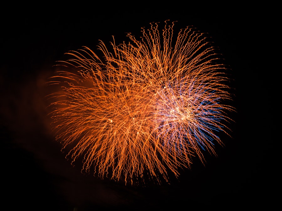 Photo: Red and blue fireworks in the night sky