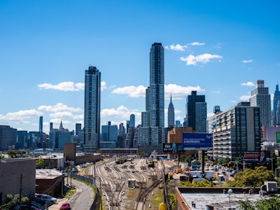 Manhattan Buildings and Train Tracks - A city skyline with tall buildings and railroad tracks