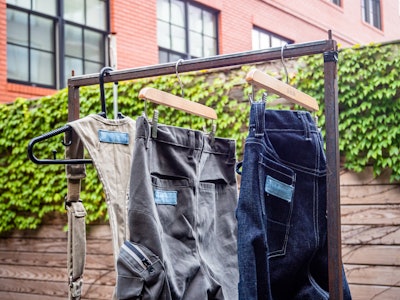 Clothing Hanging on a Rack at a Market - A pair of pants on a metal clothing rack