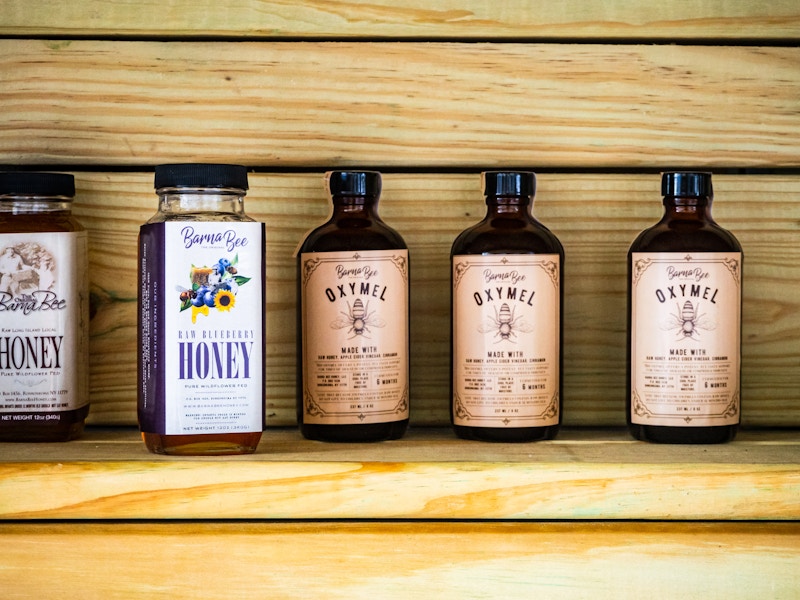 Photo: A group of honey bottles on a shelf
