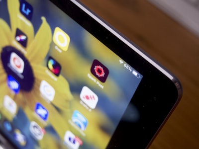 Tablet on Desk - A close up of a tablet with app icons 