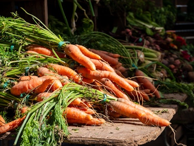 Carrots at Farmers Market - A bunch of carrots on a table at a farmers market 