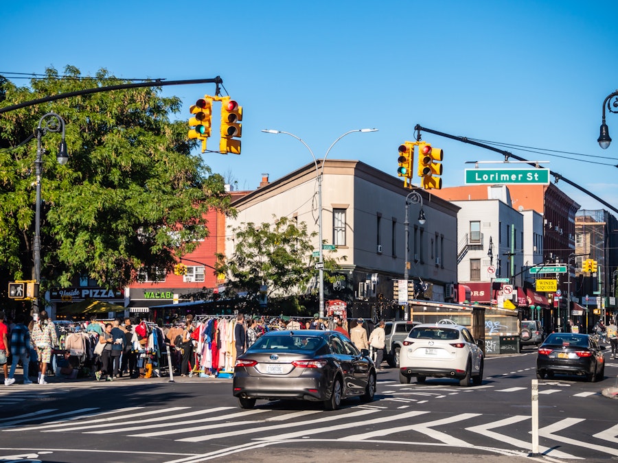 Photo: A city street with cars and people in the background