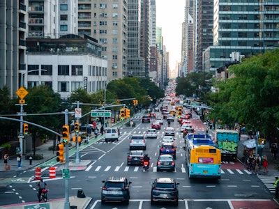 NYC Street with Cars and Buses - A busy city street with cars and buses