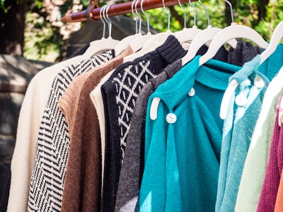 Clothing for Sale on Hanger at a Market - A group of sweaters on a clothing rack