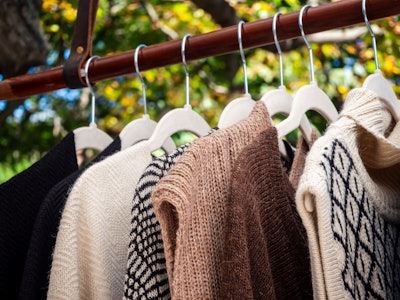 Clothing for Sale on Rack - A group of sweaters for sale on a rack