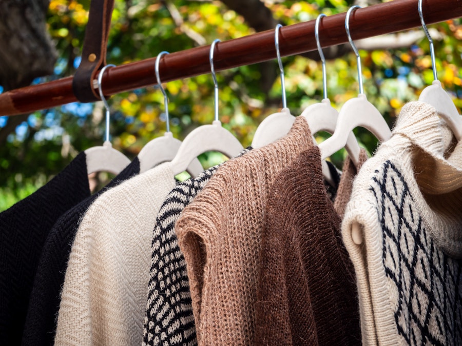 Photo: A group of sweaters for sale on a rack