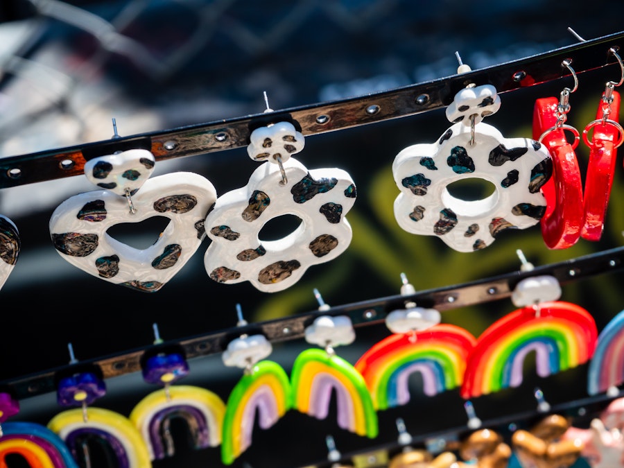 Photo: A row of earrings for sale on a metal bar