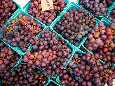 Berries at Farmers Market - Baskets of grapes in a farmers market