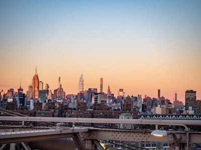 NYC Manhattan Skyline - A city skyline with a bridge and tall buildings