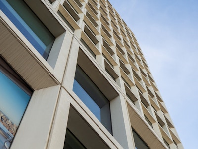 Geometric Building - A low angle view of a building with many windows