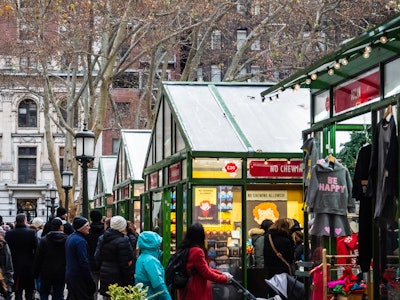 Holiday Market - A group of people walking in a city holiday market 