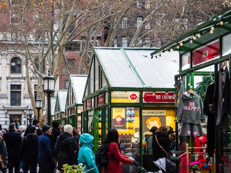 Photo: A group of people walking in a city holiday market 