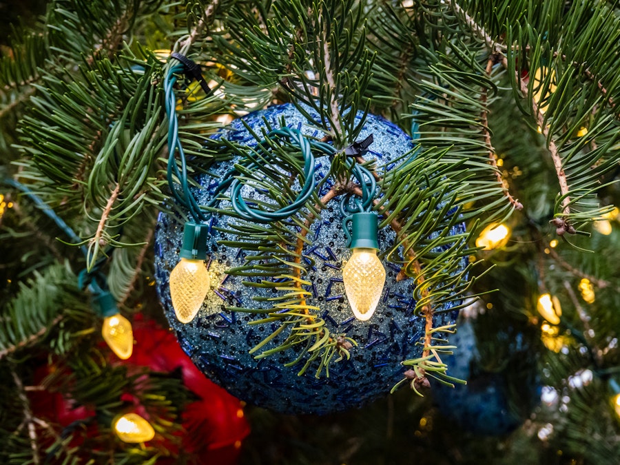 Photo: A Christmas tree with lights and blue ball ornament
