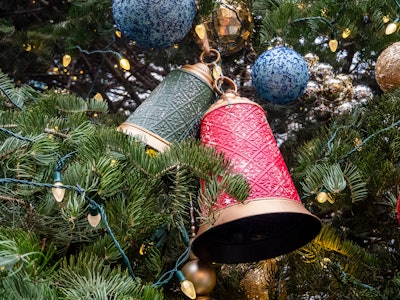 Bell Ornament on Christmas Tree - A Christmas tree with bells and lights