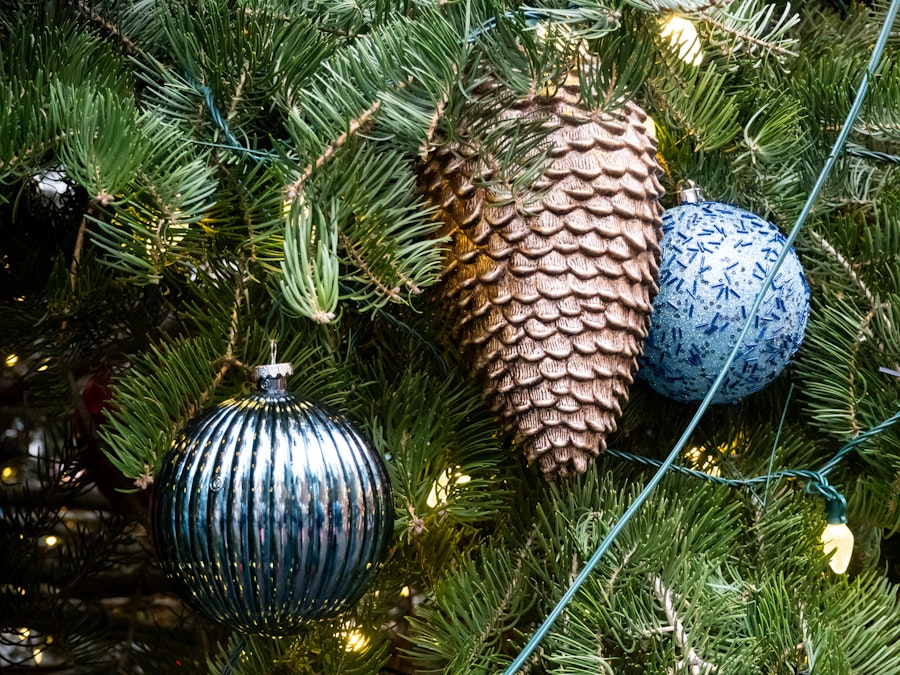 Photo: A pinecone and ornaments on a Christmas tree
