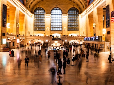 People Moving at Grand Central Terminal - A large group of focused and blurred people waiting for a train at Grand Central Terminal