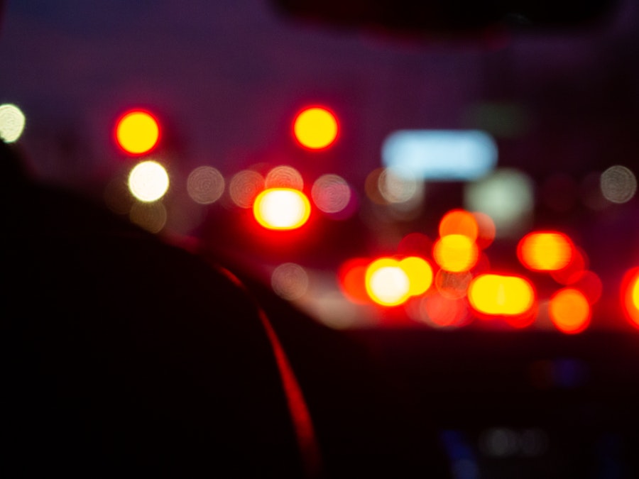 Photo: A blurry image of a city and car lights at night