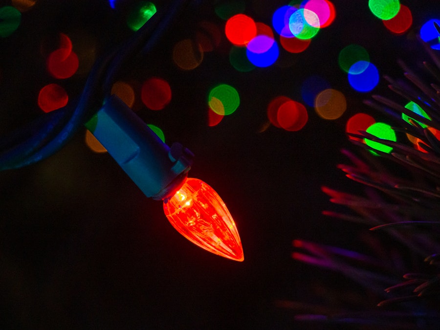 Photo: A close up of colorful lights on a Christmas tree 