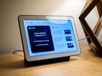 Podcast Playing on Smart Display - A smart home screen on a wooden table