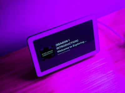 Podcast Playing on Smart Display - A smart home appliance screen under purple lighting
