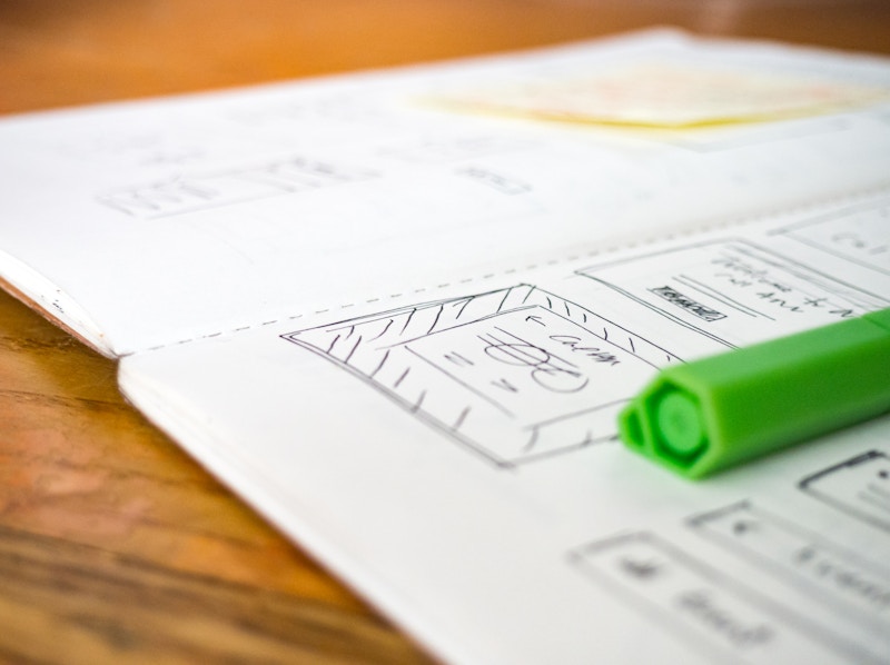 Photo: Open Sketchbook on Desk with Green Pen